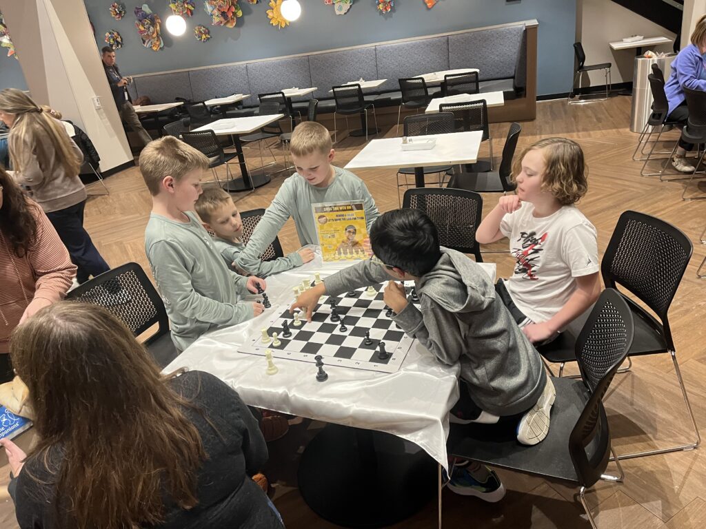 Chess lesson around a table